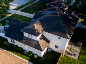 Aerial view of suburban home exterior with complex roof design, highlighting proportions, materials, and layout for renovation planning and cohesion.