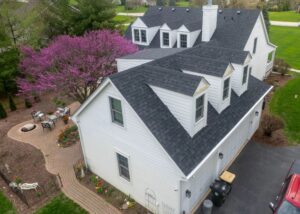 Aerial view of home with new roof and siding, illustrating uniform appearance achieved through proper roofing and siding matching coverage repairs.