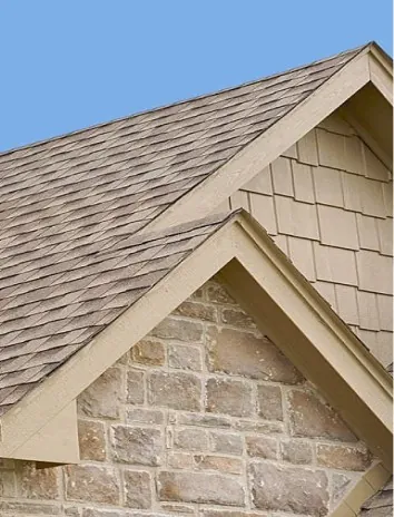 Stone siding with the same color roofing. Natural stone exterior